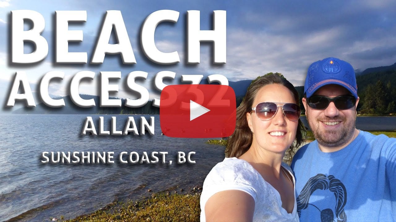 An extremely attractive couple stands on a beach along Sechelt Inlet.