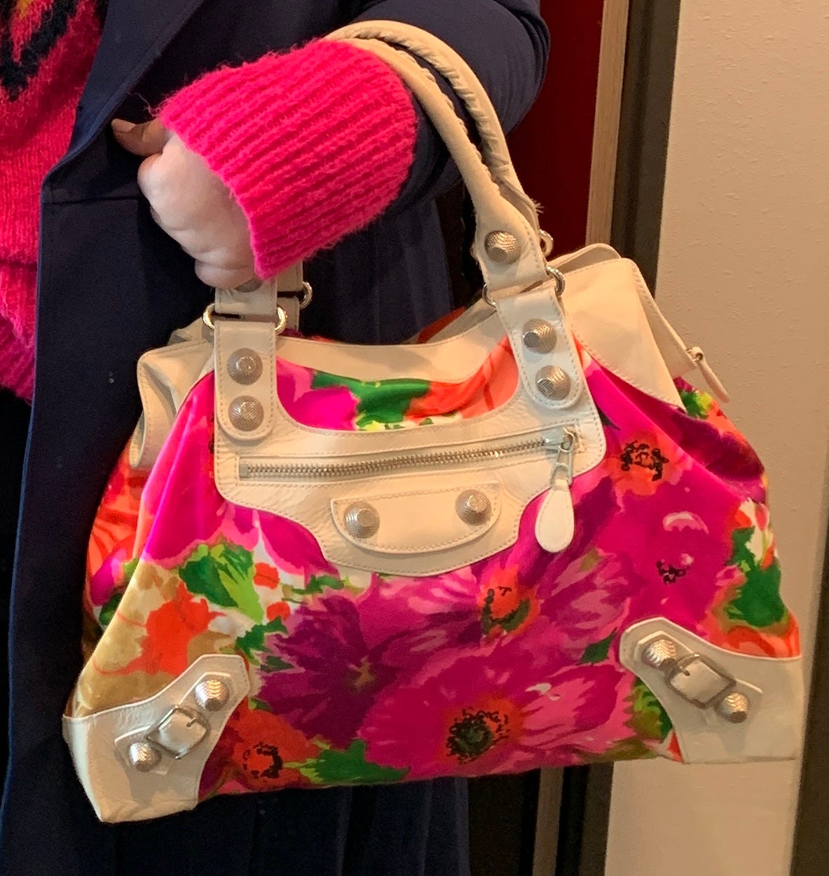 Balenciaga bag with hot pink, purple, orange and gold flowers on satin fabric with white leather trim.