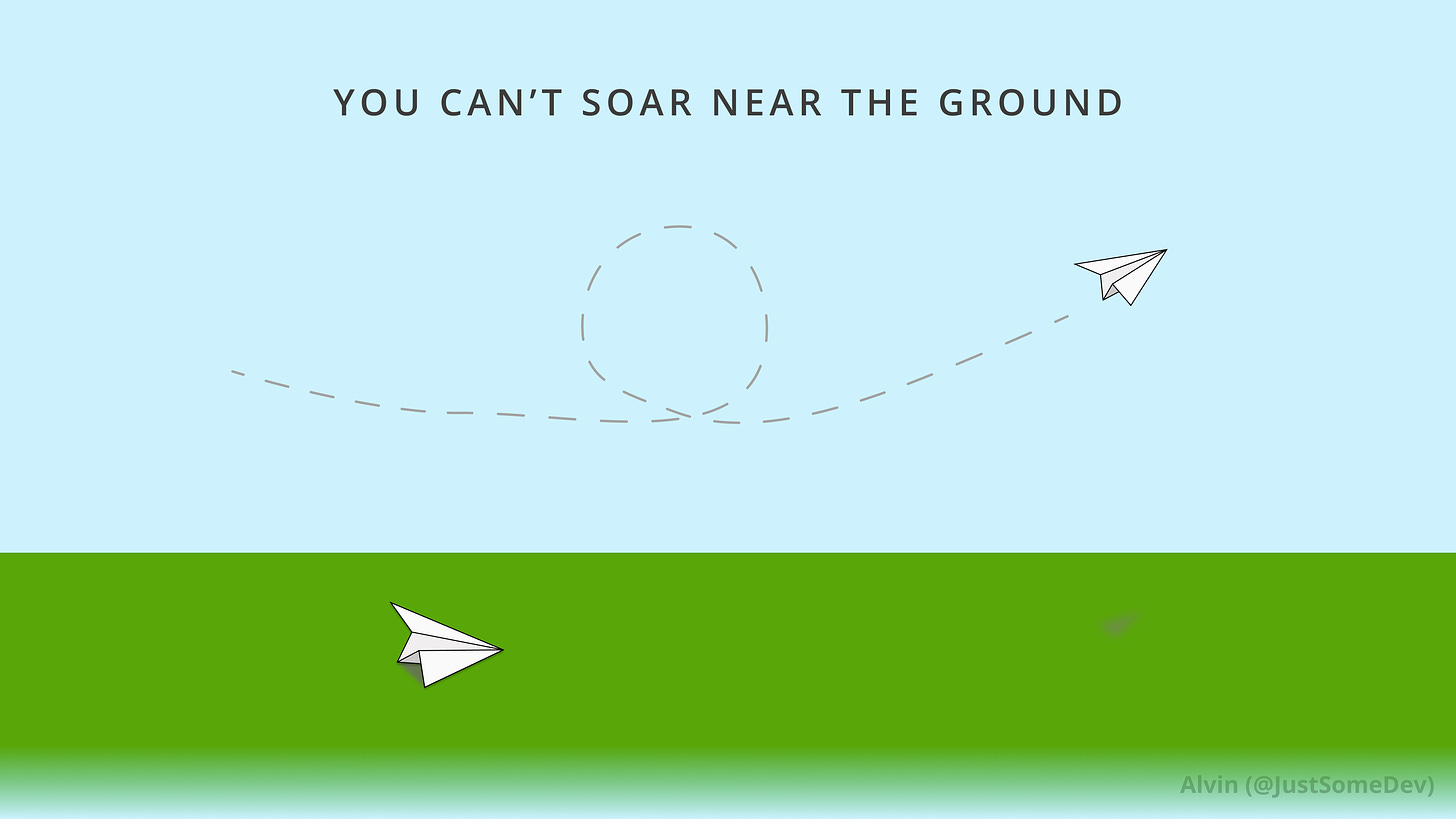 A paper airplane rests on the ground while another soars through the air. You can’t soar near the ground.