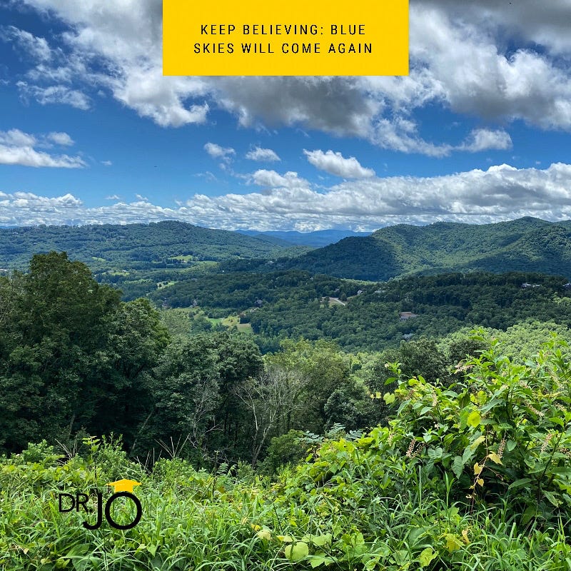 Dr. Jo: image depicts blue skies and a sunny day overlooking Blue Ridge Mountains. Text says, "Keep believing: blues skies will come again."