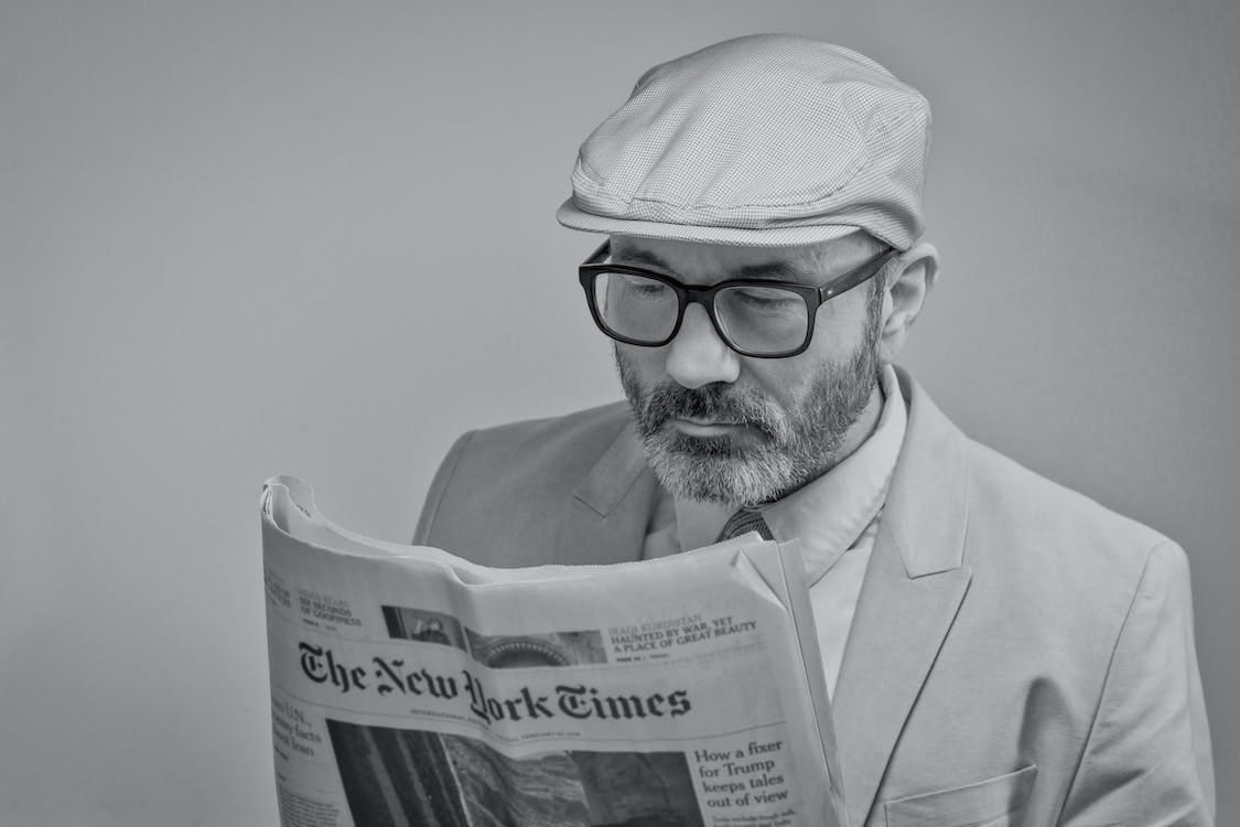 Free Man Reading a Newspaper Stock Photo