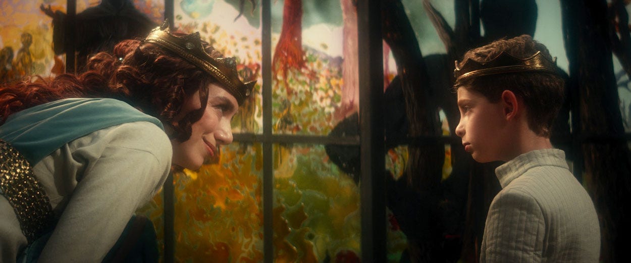 This image shows Yvette Picard (played by Madeline Wise) dressed as a queen (and wearing a crown) as she talks with her son, young Jean-Luc Picard (Dylan Von Halle), who's dressed as a prince, in a crucial scene from Star Trek: Picard Season 2's seventh episode, titled "Monsters." This image shows Yvette Picard (played by Madeline Wise) dressed as a queen (and wearing a crown) as she talks with her son, young Jean-Luc Picard (Dylan Von Halle), who's dressed as a prince, in a crucial scene from Star Trek: Picard Season 2's seventh episode, titled "Monsters."