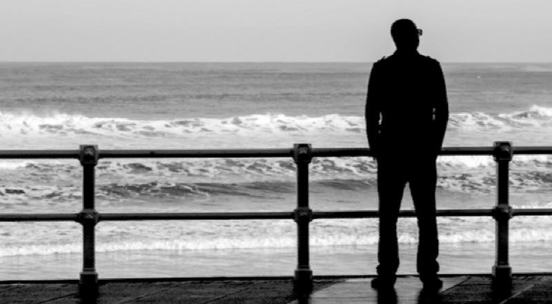 person overlooking surf