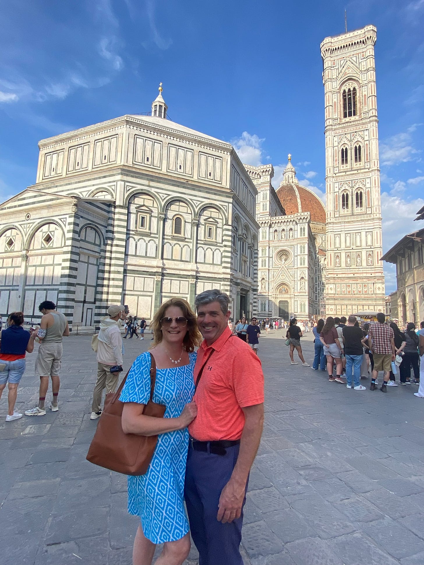 50-something couple poses in front of Florence's Duomo