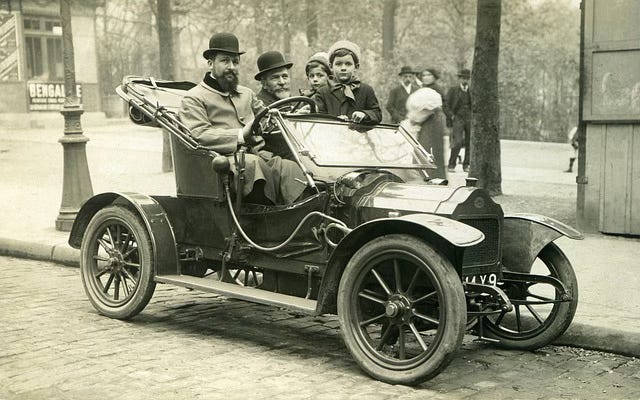 Antique car with people in it