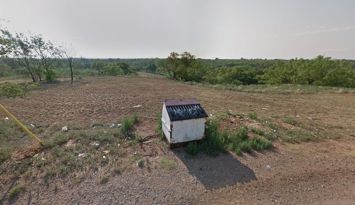 Street View image of dumpster and undeveloped land