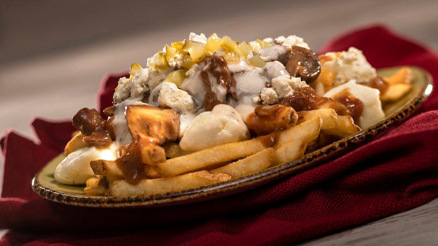 Braised Beef Poutine: French fries with braised beef, Boursin Garlic & Fine Herbs cheese sauce, cheese curds, crumbled Boursin Garlic & Fine Herbs, and gherkin relish