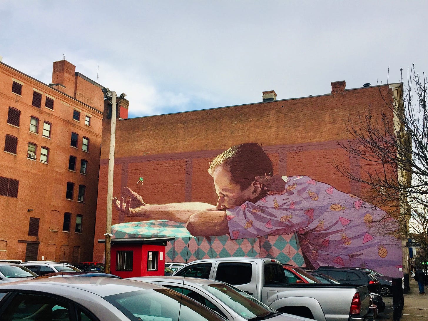 A mural of a man tossing a ring into the air, looking forlorn