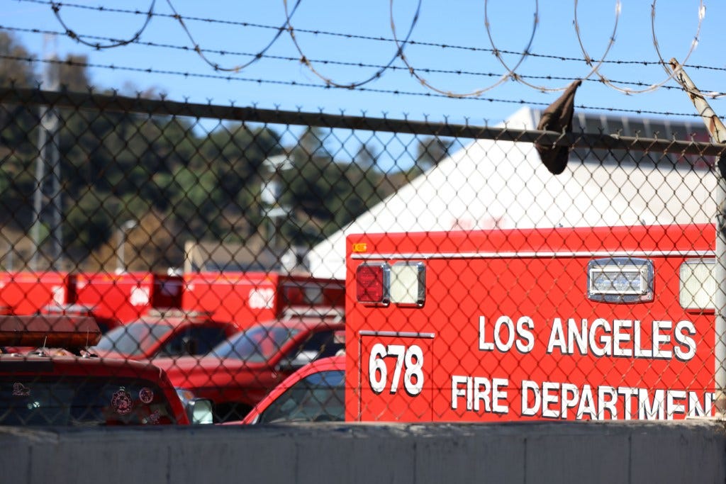 More Fire fighting trucks parked in the lot, unused 