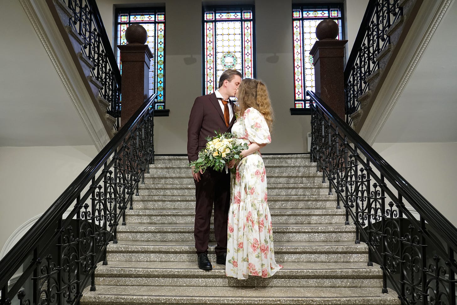 Peter Imanuelsen on staircase with Camilla Rose Imanuelsen wedding kiss