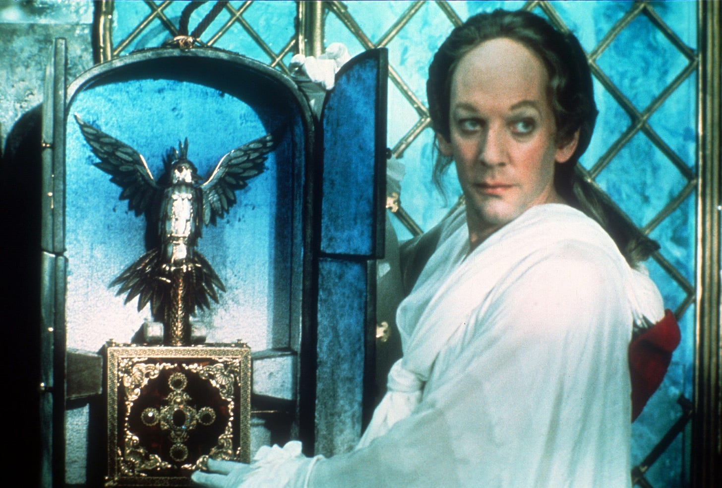 Still from Fellini’s Casanova (1976). Donald Sutherland as Casanova stands beside a religious icon or relic in the shape of an eagle. 
