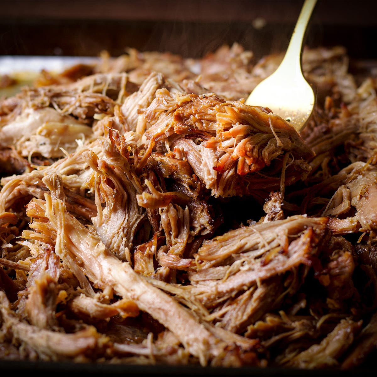 A plate filled with pork carnitas that are ready to eat.