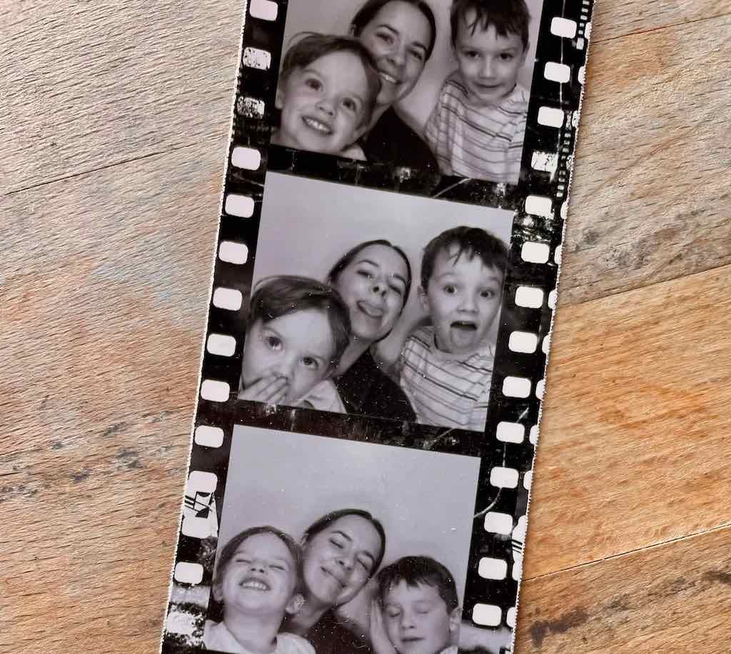 A photobooth strip of photos of the author with her two young sons.