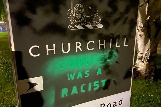 XR protestors graffitied the Churchill College sign