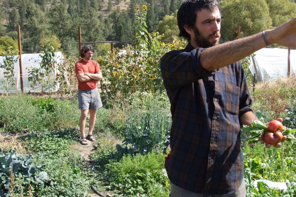 Local farmer Brian Estes, foreground, stands with Kai Huschke, campaign director of Envision Spokane and leader of Proposition 1 at Estes' Vinegar Flats garden. (Paul K. Haeder / Down to Earth NW Correspodent)