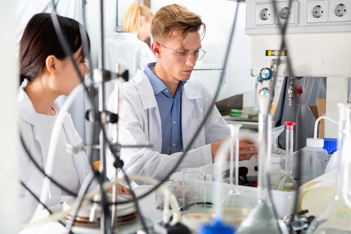 Two young scientists working together in a research lab.