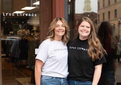 Two women standing next to each other

Description automatically generated