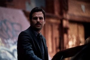 An image from In the Cut of Ruffalo as Malloy, with a bizarre handlebar moustache 