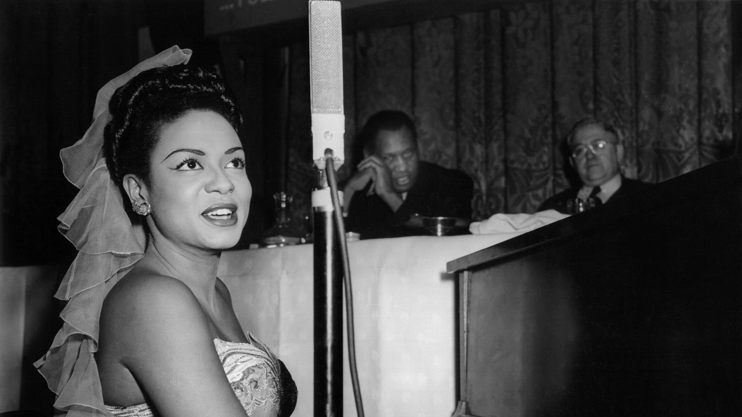 Hazel Scott sings and plays piano at a dinner being held in honor of Hugh Mulzac the first African American captain in...