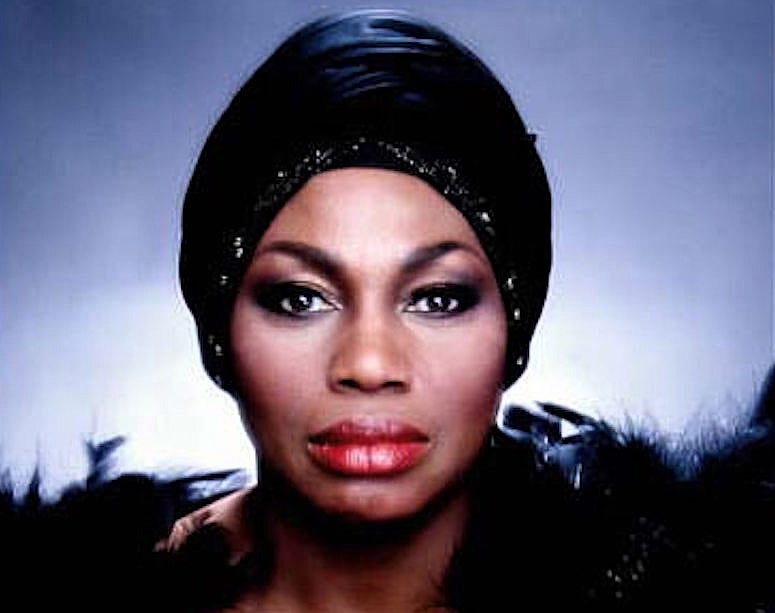 Color photo of opera star Leontyne Price wearing a black turban. Color photo of opera star Leontyne Price wearing a black turban.