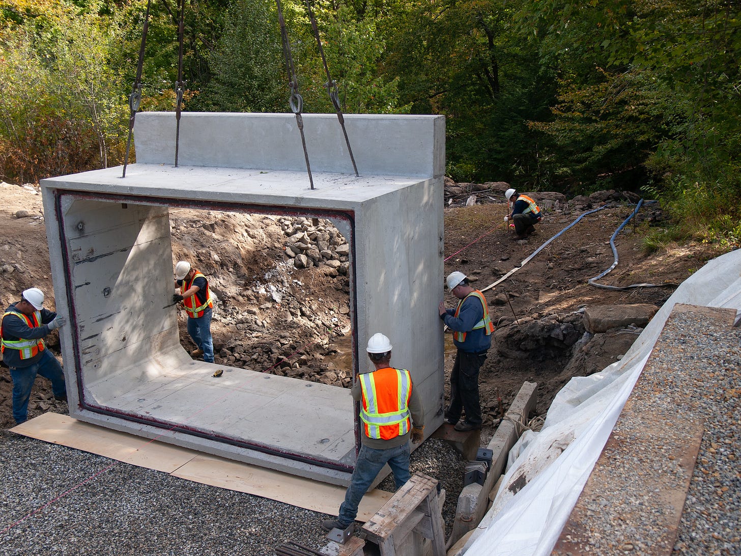 Workmen with a precast section of a bridge