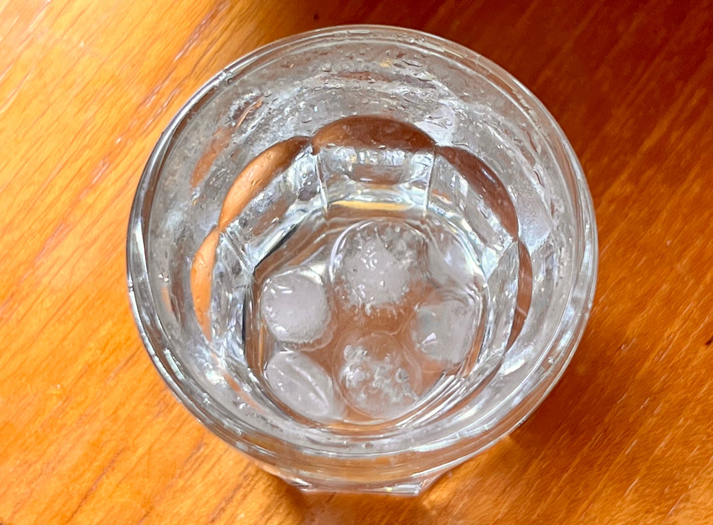 An overhead image of a shot glass with the reminanse of some sluice in the bottom