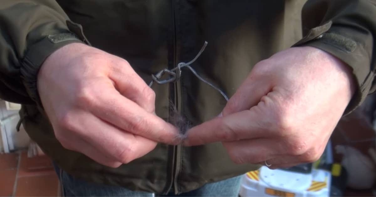 Hands display a now-cut self-locking snare to the camera.