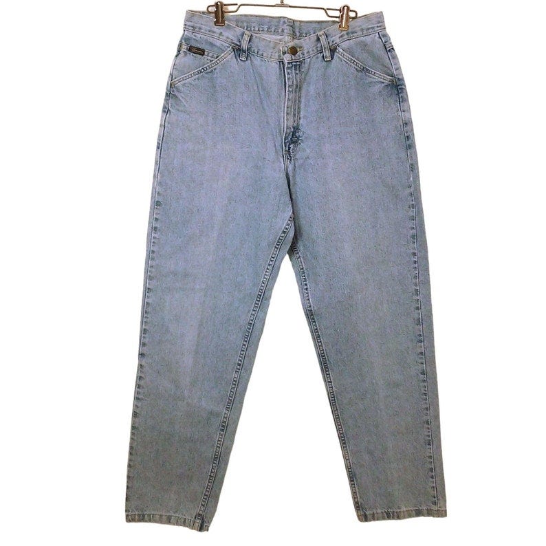 May include: Light blue denim jeans with a straight leg fit.