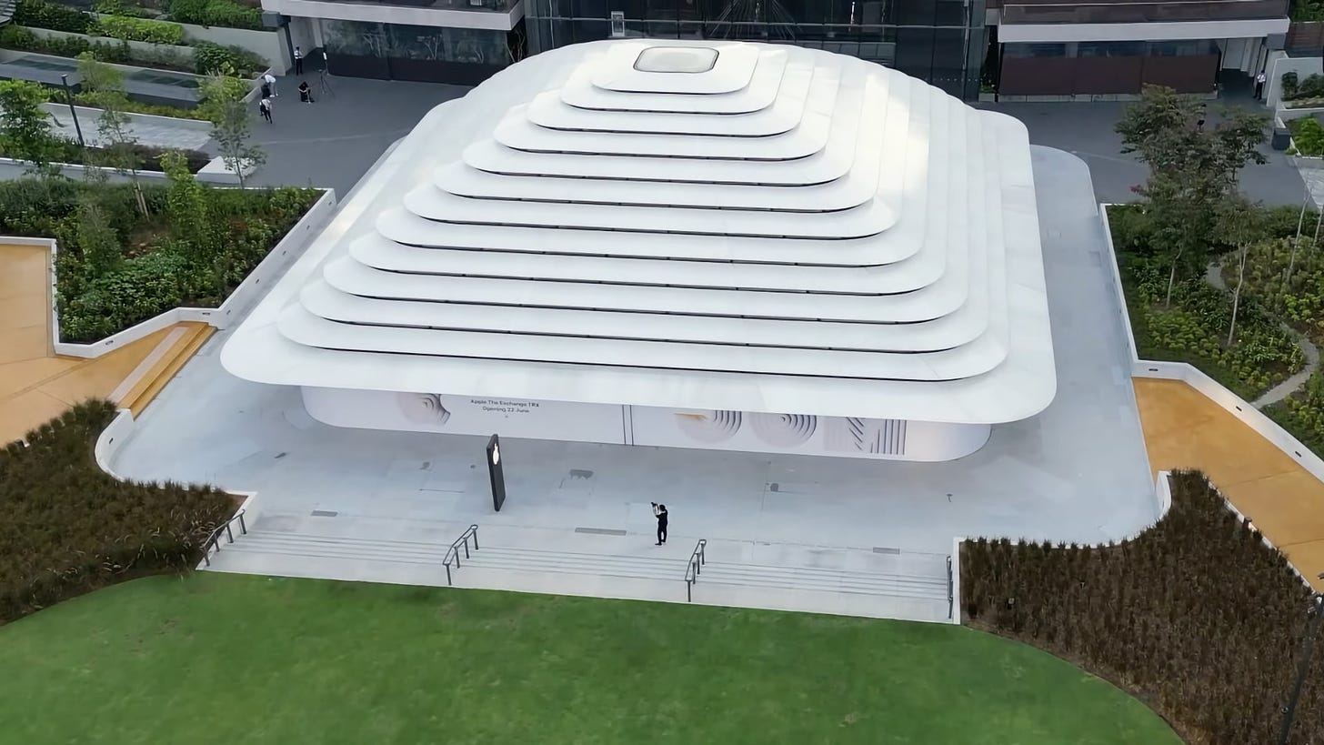 Apple The Exchange TRX photographed by a drone. The roof is a series of tiered rounded rectangles. In the center of the roof is a skylight.