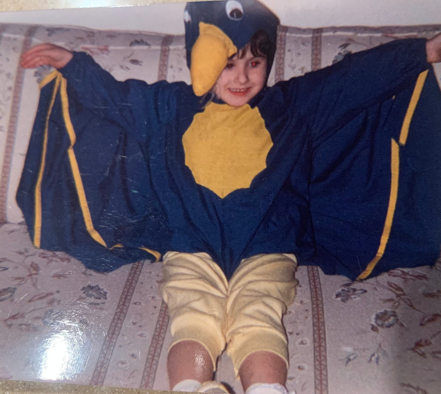 Child Lyric, dressed as a green and yellow pterodactyl