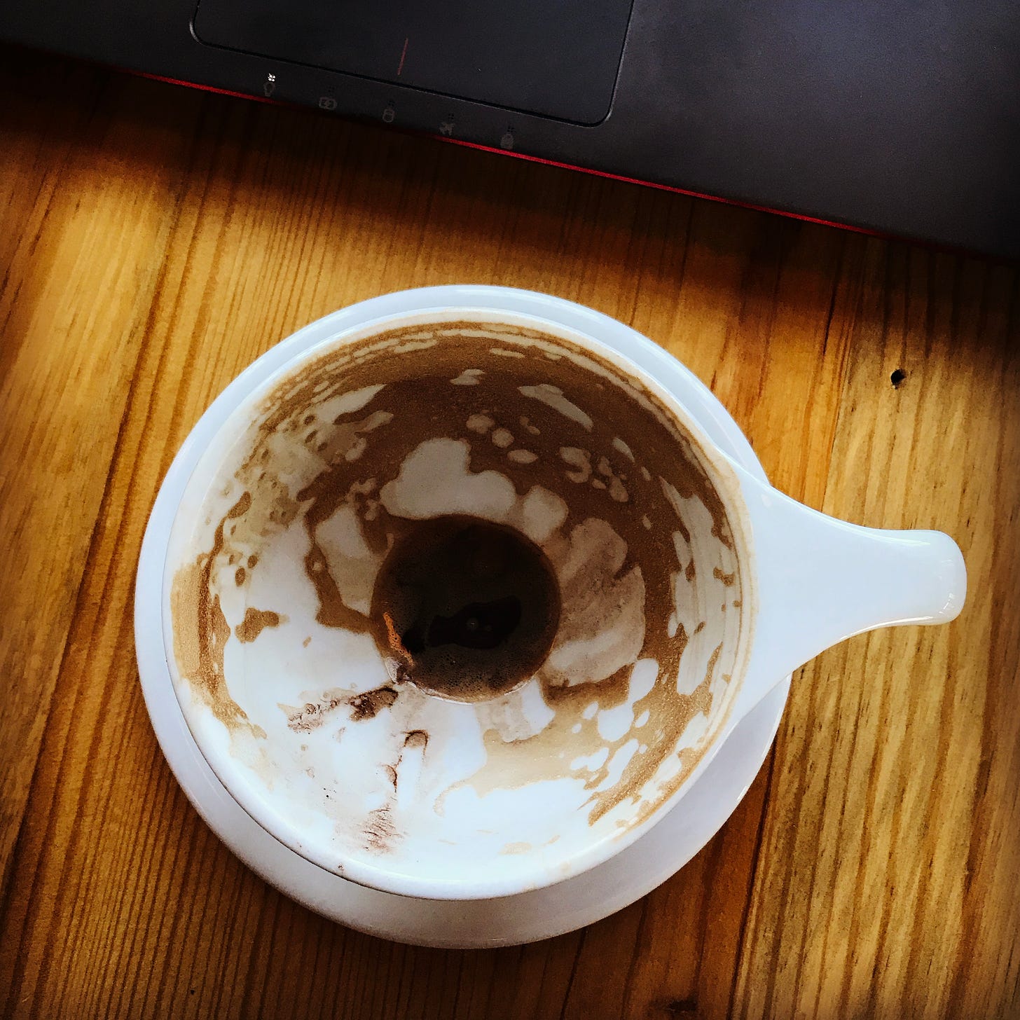 an almost empty coffee cup.