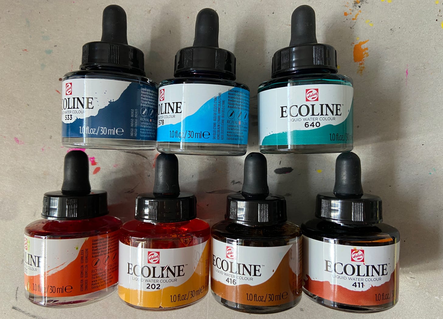 photograph of seven bottles of Ecoline liquid watercolour in various colours