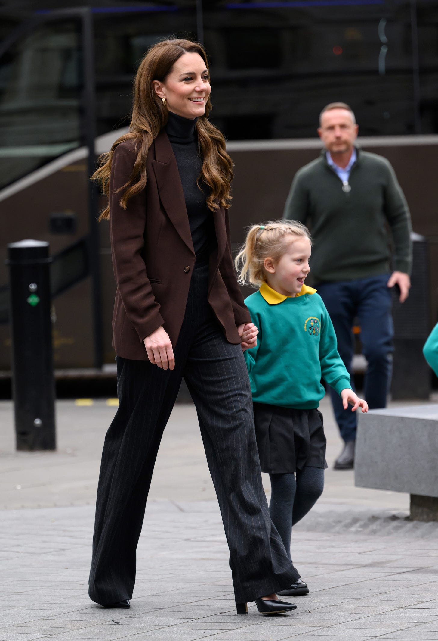 Princess of Wales walking with school child