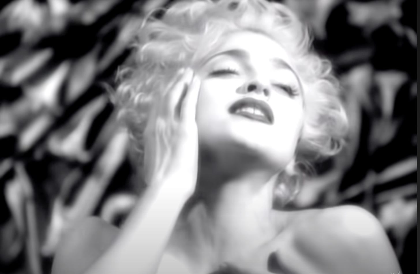 madonna in the vogue video, with bare shoulders and touching her face