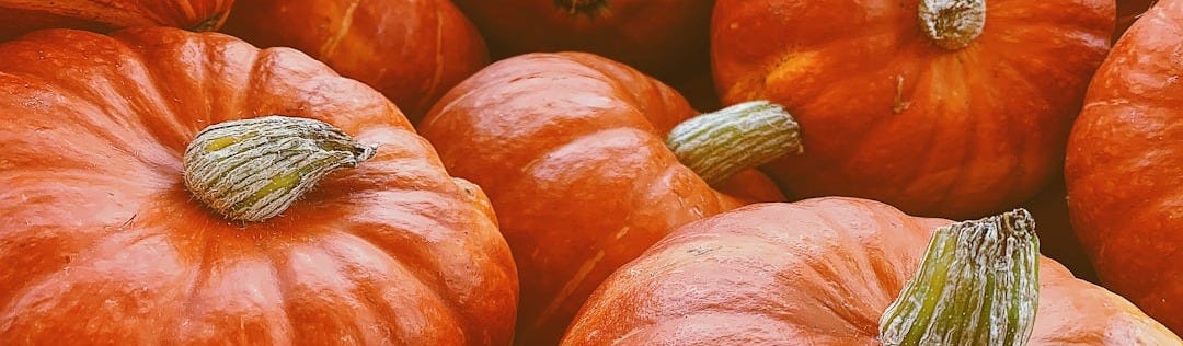 orange and green vegetables on brown wooden table orange and green vegetables on brown wooden table