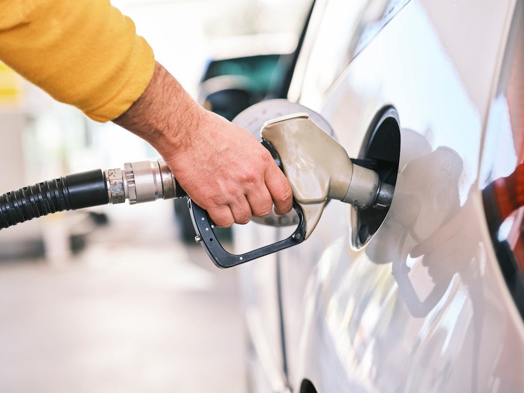 Pumping gas at gas pump. Closeup of man pumping gasoline fuel in car at gas station. Pumping gas at gas pump. Closeup of man pumping gasoline fuel in car at gas station.