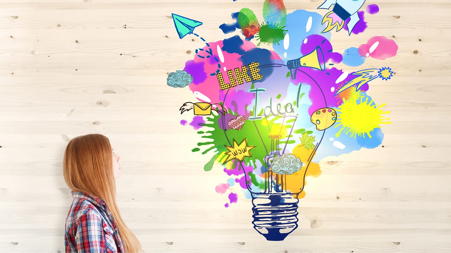 Woman looking at a big, colorful, creative lightbulb