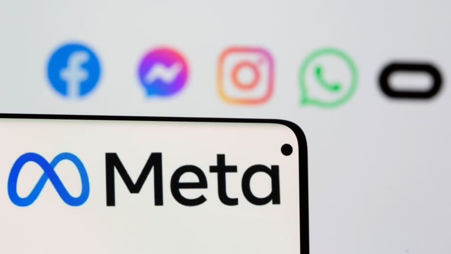 Facebook's new rebrand logo Meta is seen on smartpone in front of displayed logo of Facebook, Messenger, Intagram, Whatsapp and Oculus in this illustration picture taken October 28, 2021.
