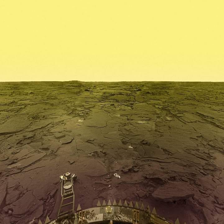 A desolate rocky plain underneath a hazy yellow sky. 