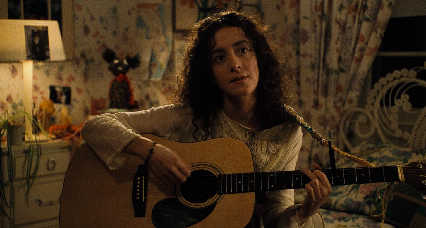 Happiness | Still features Jane Adams as Joy Jordan playing a guitar.