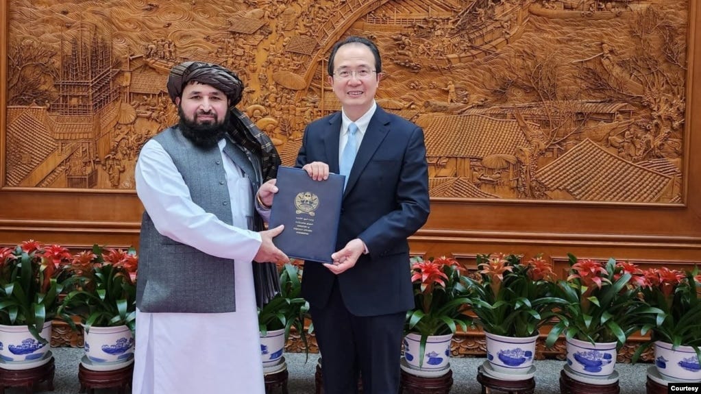 In this photo provided by the Taliban, newly appointed Taliban ambassador Assadullah Bilal Karimi is reportedly presenting his credentials to Hong Lei, director-general of the protocol department at China's Foreign Ministry, in Beijing on Dec. 1, 2023.