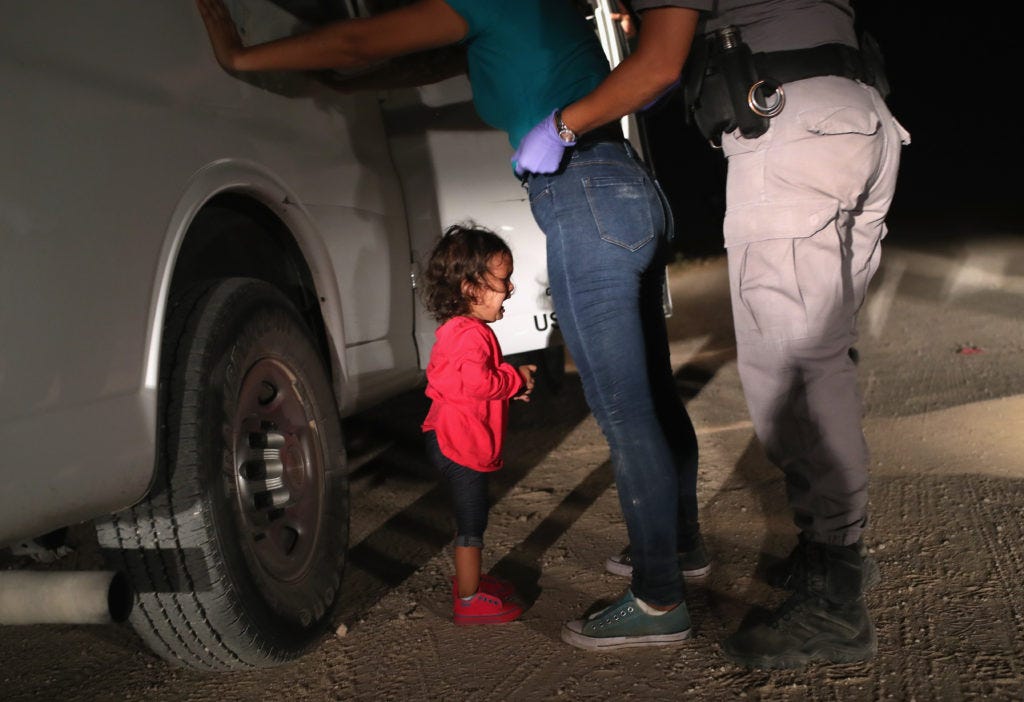 MCALLEN, TX - JUNE 12: A two-year-old Honduran asylum seeker cries as her mother is searched and detained near the U.S.-Me...