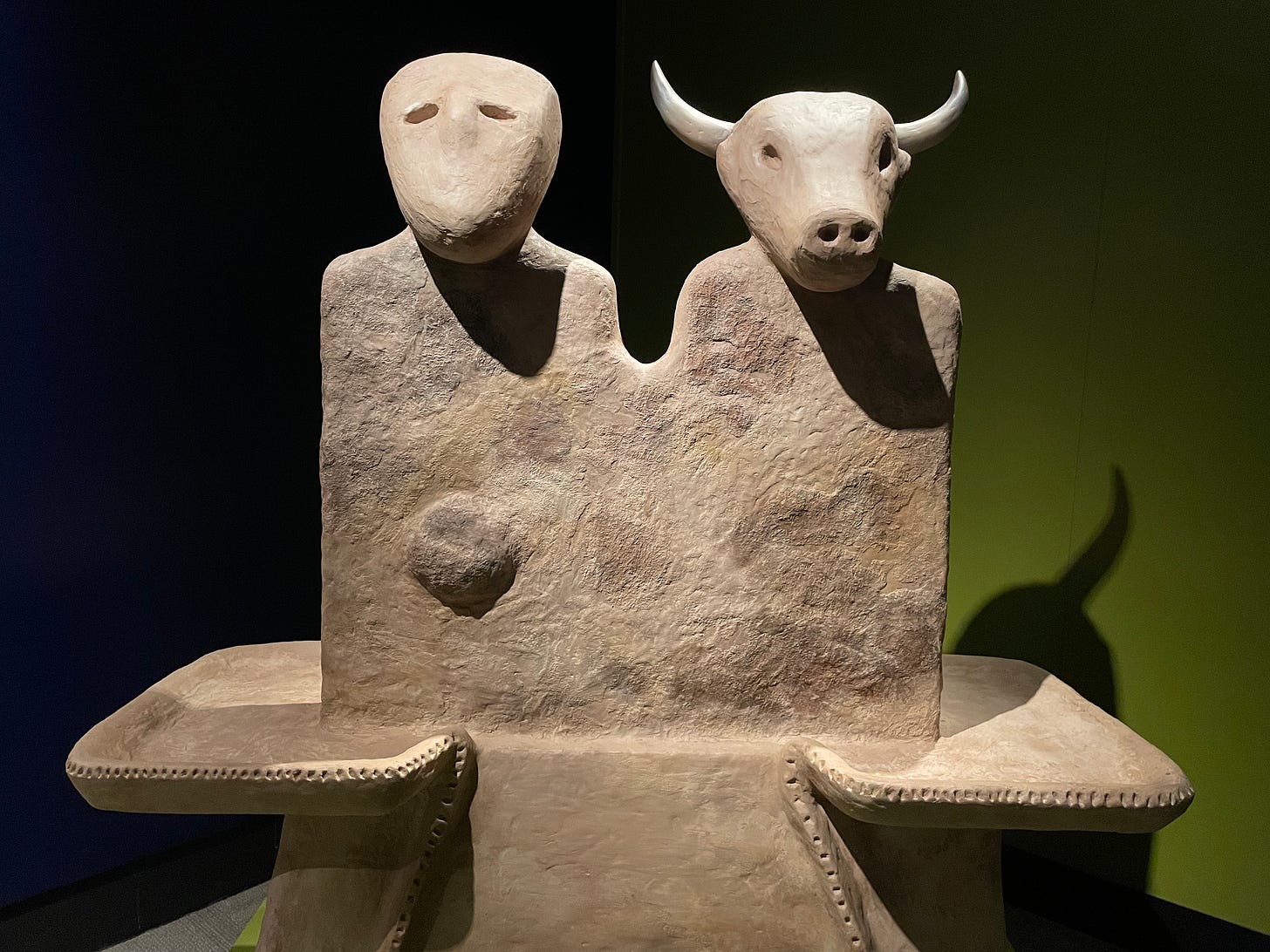 a stone statue of a human figure and a bull figure, believed to be used to Neolithic worship
