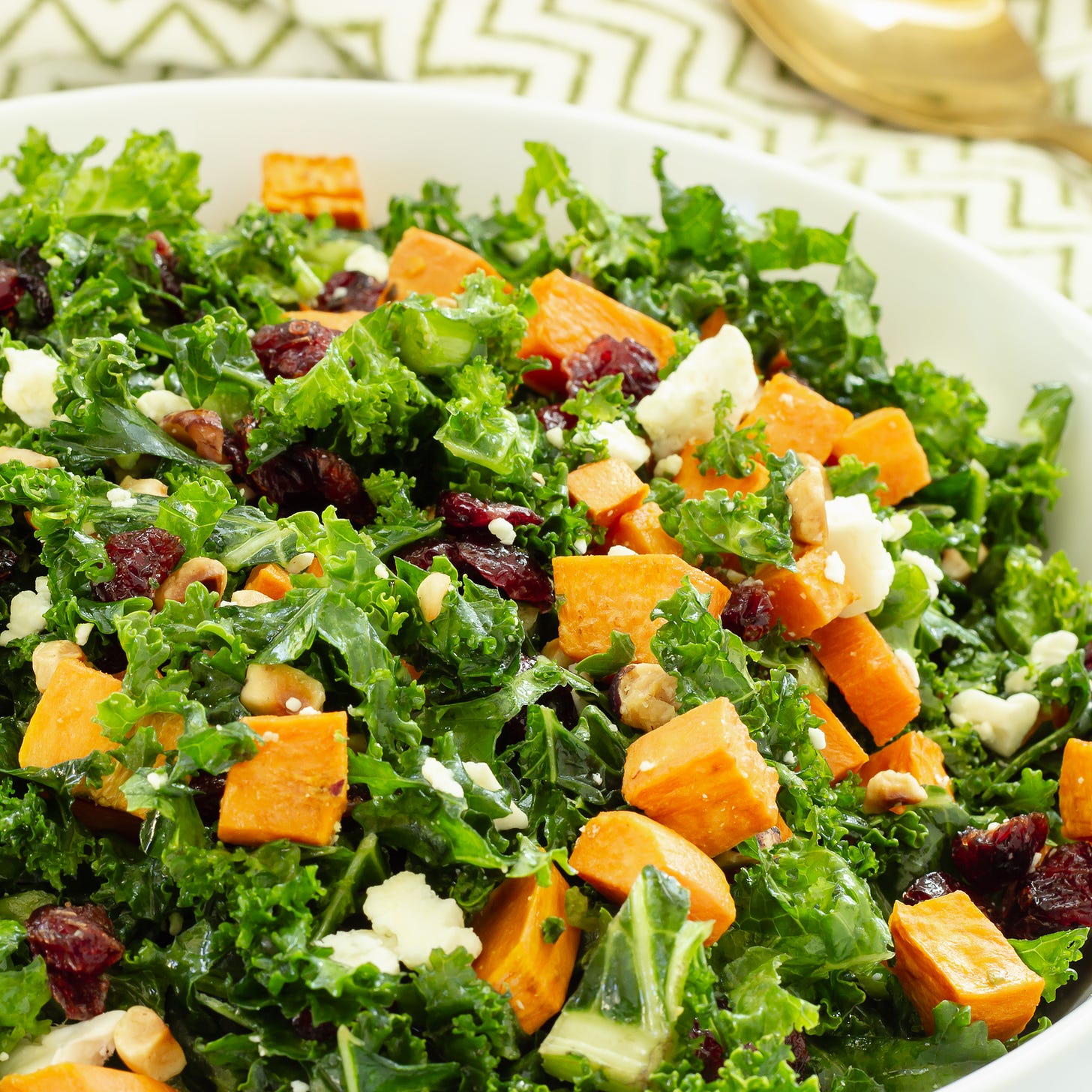 fall harvest salad in bowl with spoon.