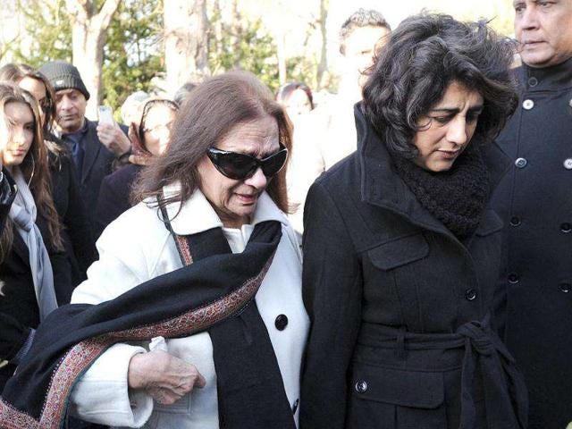 Mona (L) and Devina Anand, the wife and daughter of film star Dev Anand, attend his funeral service in London. AFP/Carl Court