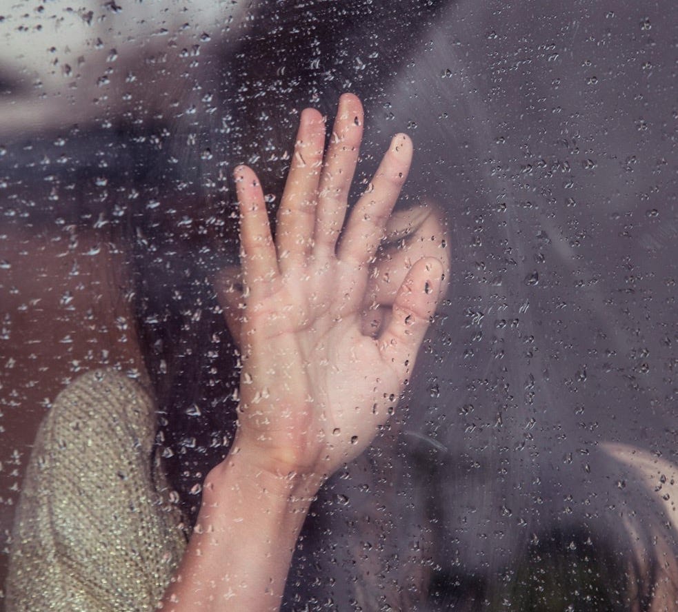 woman touch rainy glass woman touch rainy glass