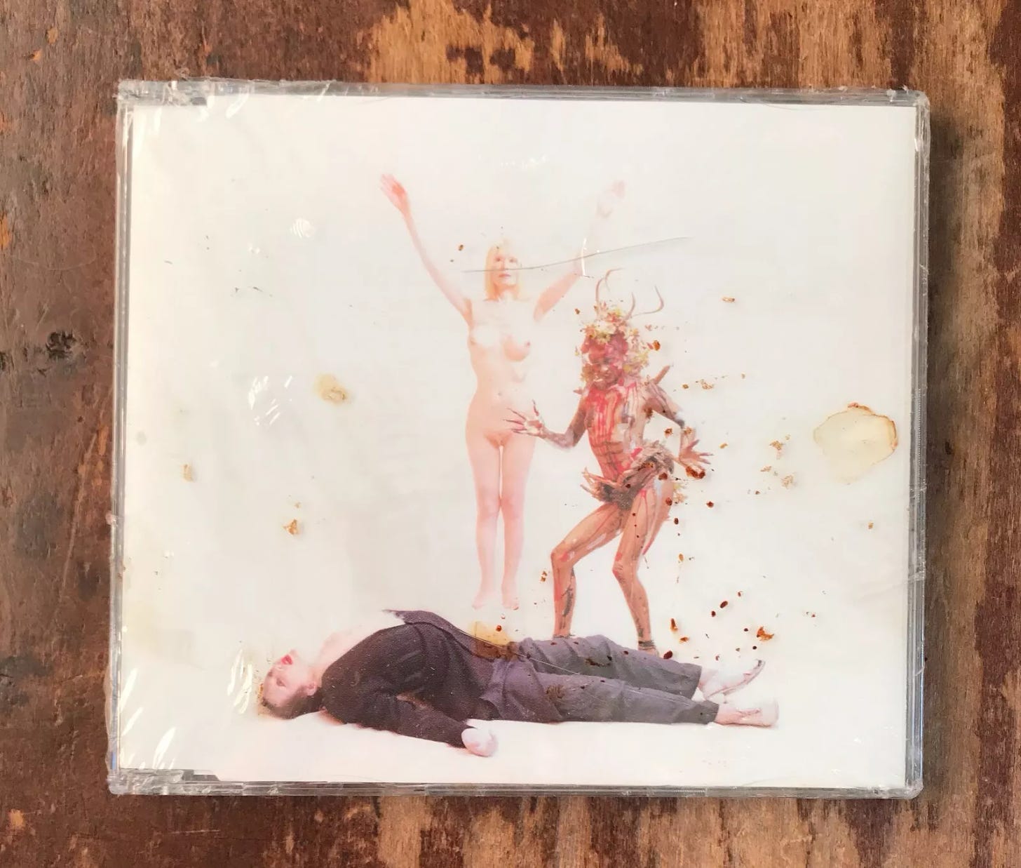 Cover for the UK Maxi-Single "I Fell in Love with a Dead Boy by Antony & the Johnsons Pictured: the body of a boy on the ground courted by a demon and an angel of death.