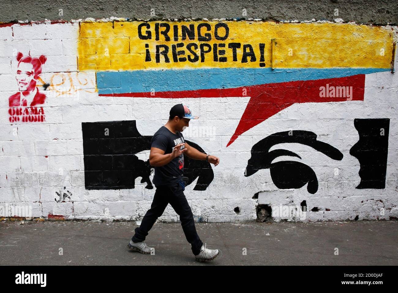 A man walks past graffiti depicting U.S. President Barack Obama in Caracas  March 16, 2015. Venezuela's parliament granted President Nicolas Maduro  decree powers on Sunday for the rest of 2015 in a