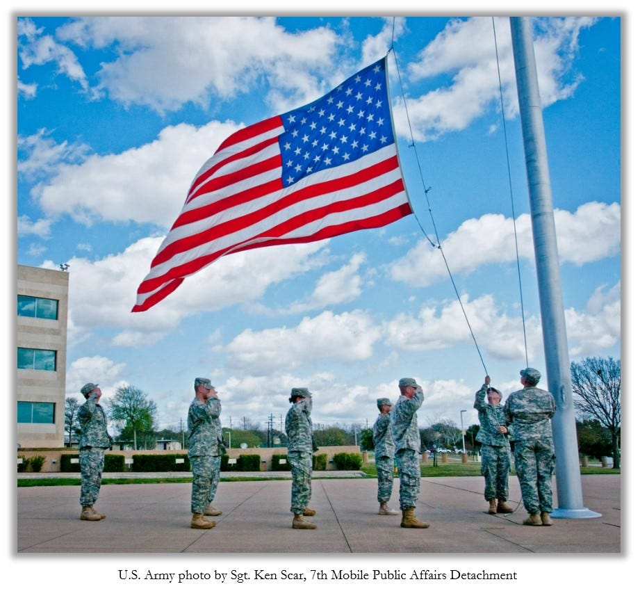 The U.S. flag is raised as soldiers salute.