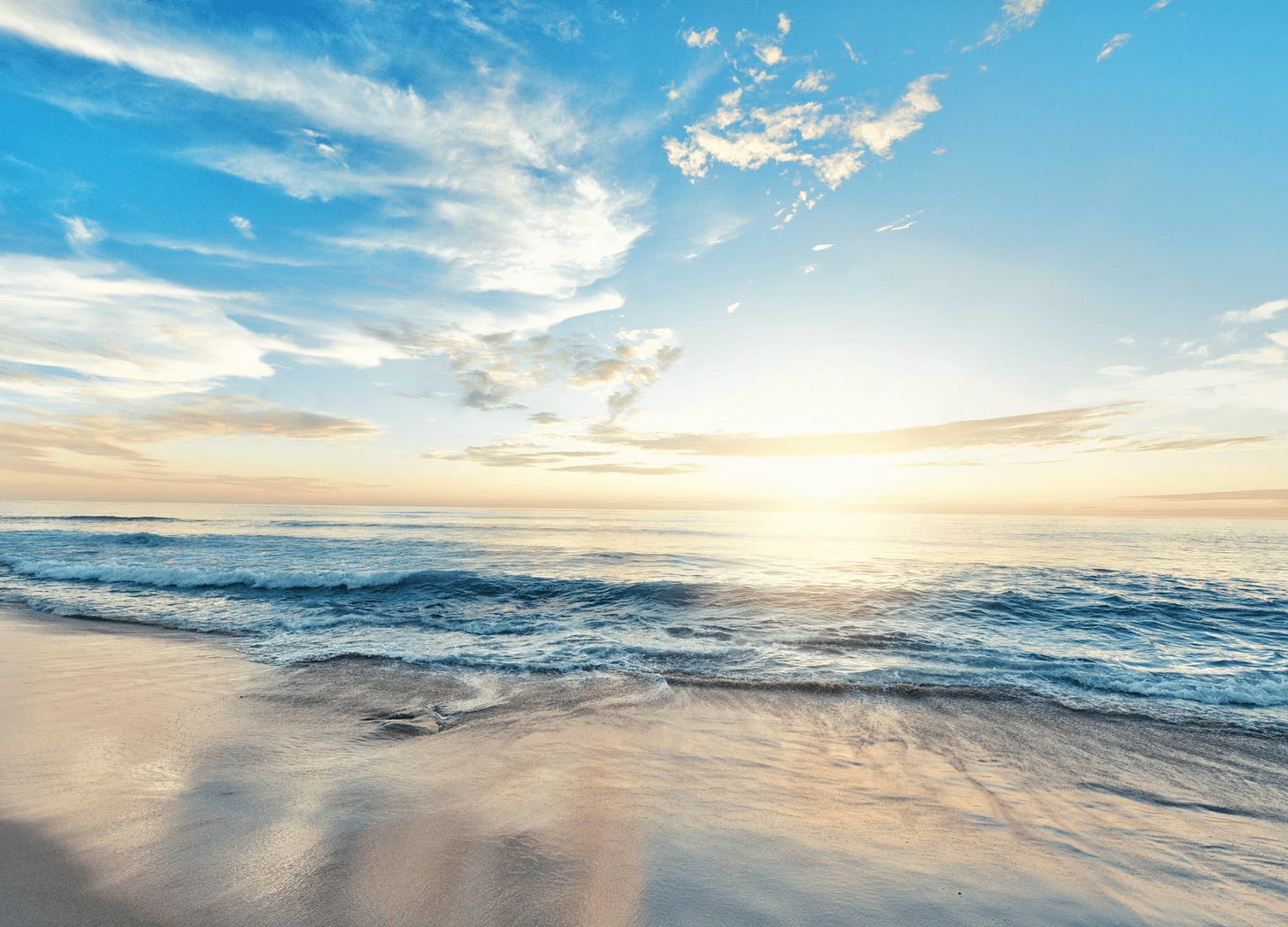 Ocean waves on a beach with dramatic sky